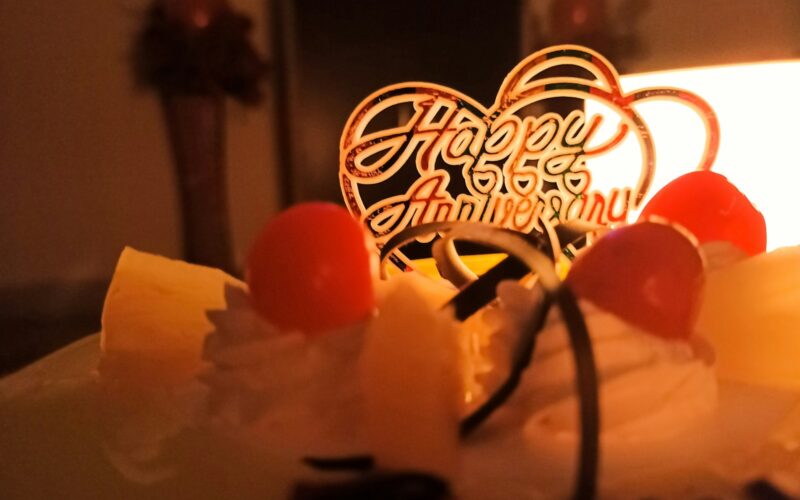 white cake with red cherry on top